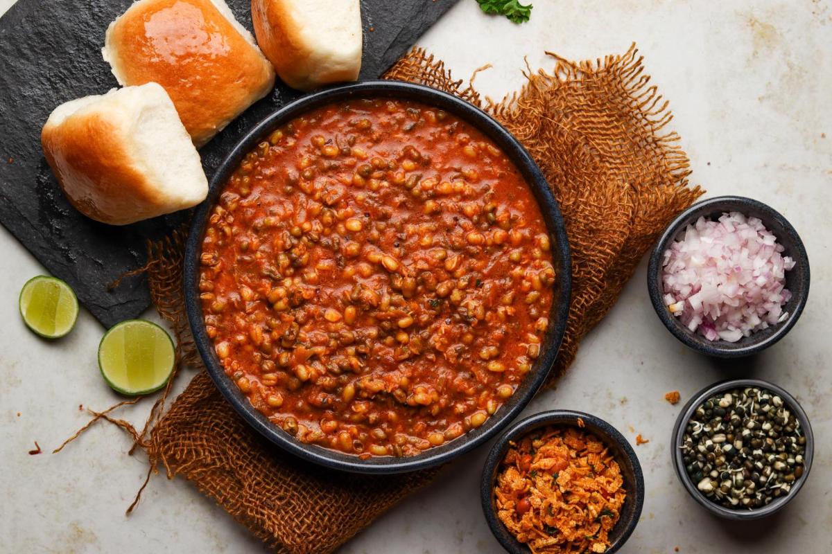 a bowl of chili next to some bread and other ingredients at Hyatt Hyderabad Gachibowli in Hyderabad