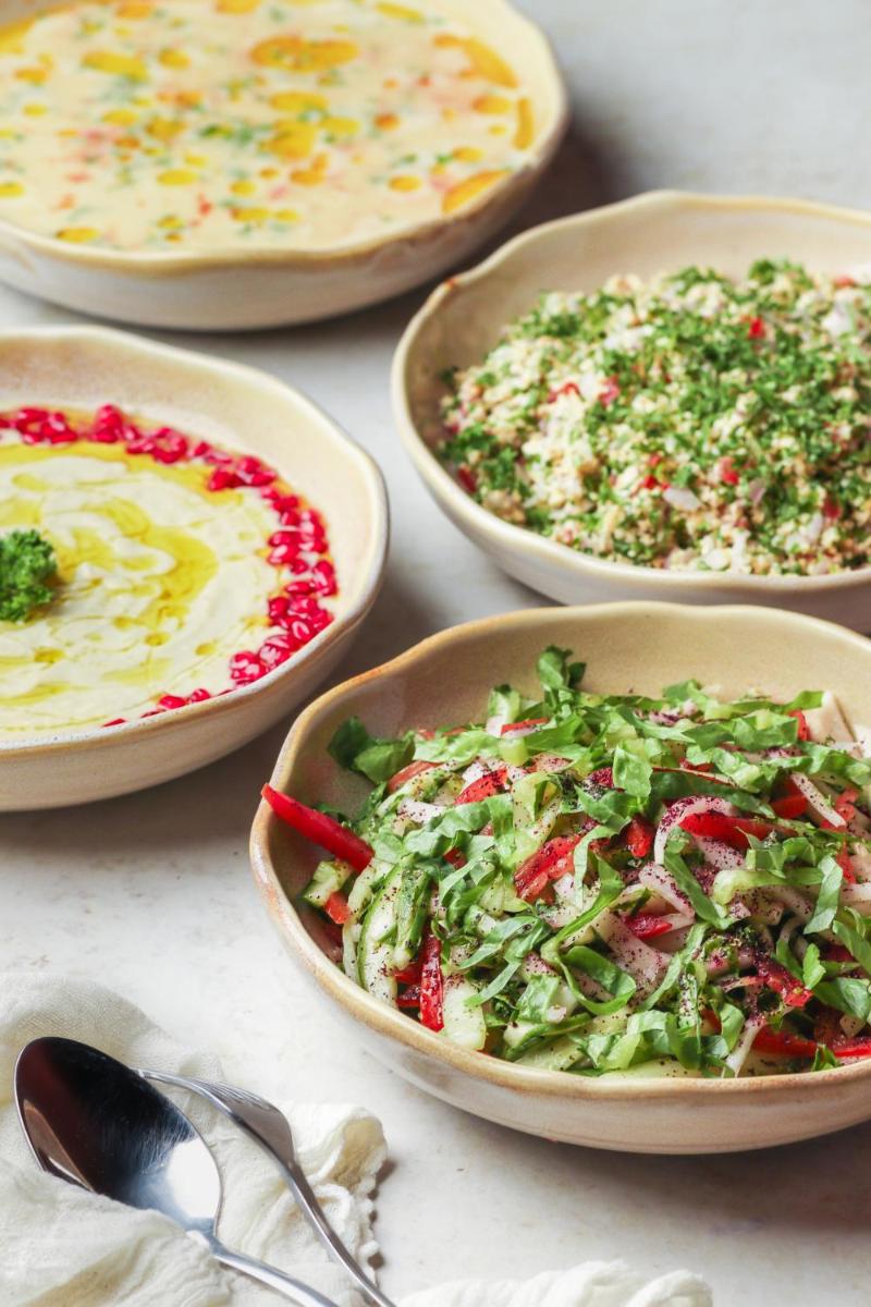 a table with four bowls of different types of food at Hyatt Hyderabad Gachibowli in Hyderabad