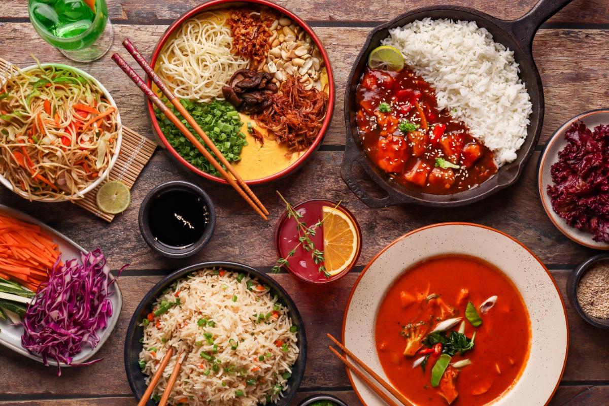 a table topped with bowls of different types of food at Hyatt Hyderabad Gachibowli in Hyderabad