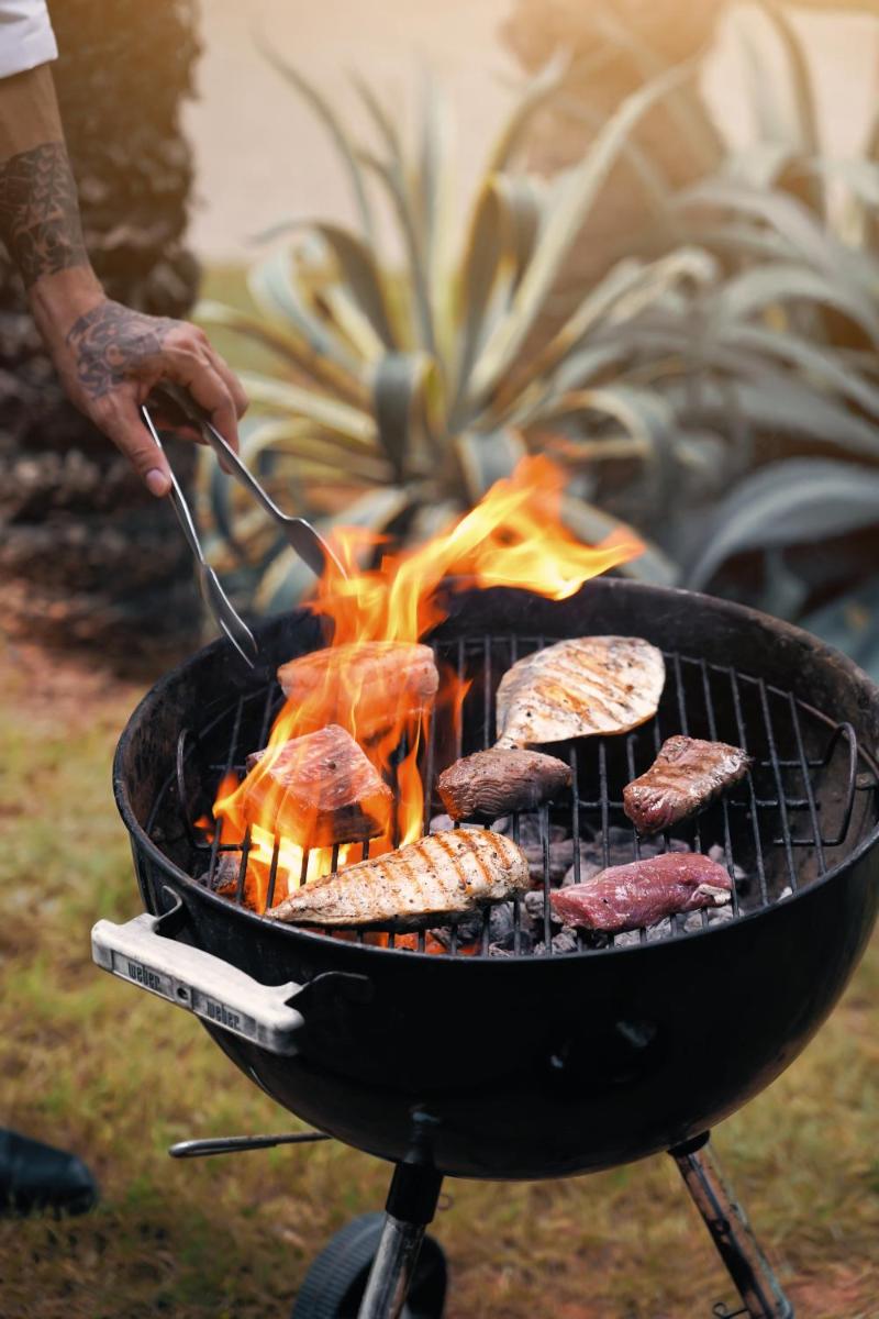 a person is cooking food on a grill at Hyatt Hyderabad Gachibowli in Hyderabad