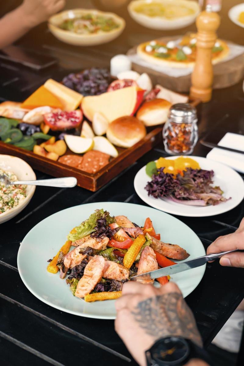 a table with plates of food on a table at Hyatt Hyderabad Gachibowli in Hyderabad