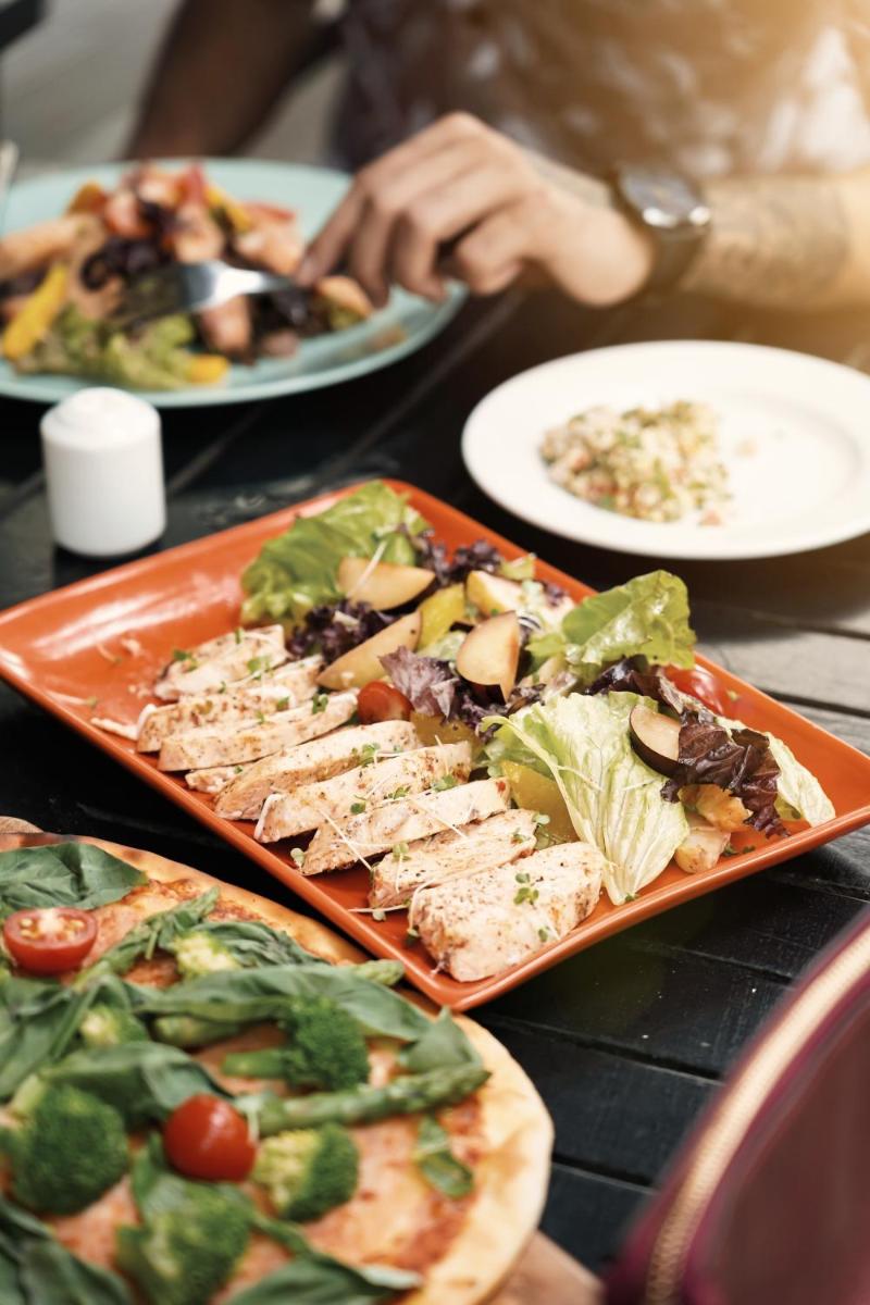 a tray of food on a table with plates of food at Hyatt Hyderabad Gachibowli in Hyderabad