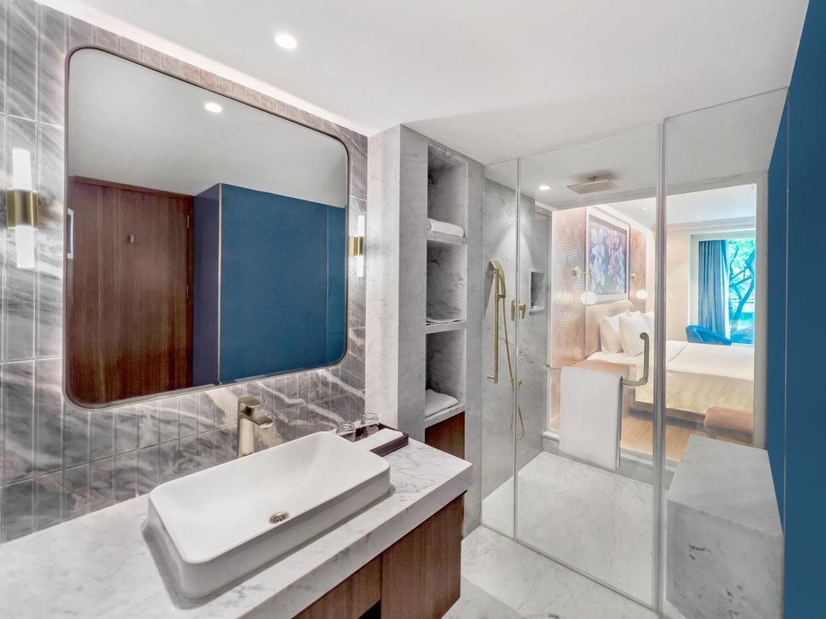 a bathroom with a sink and a mirror at Radisson Blu Hotel & Suites GRT Chennai in Chennai