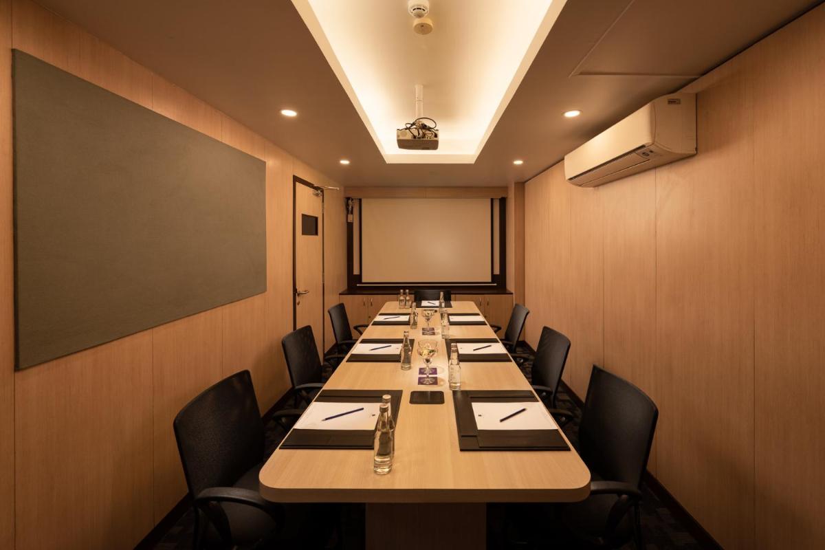 a conference room with a long table and chairs at Grand Mercure Bangalore - An Accor Brand in Bengaluru