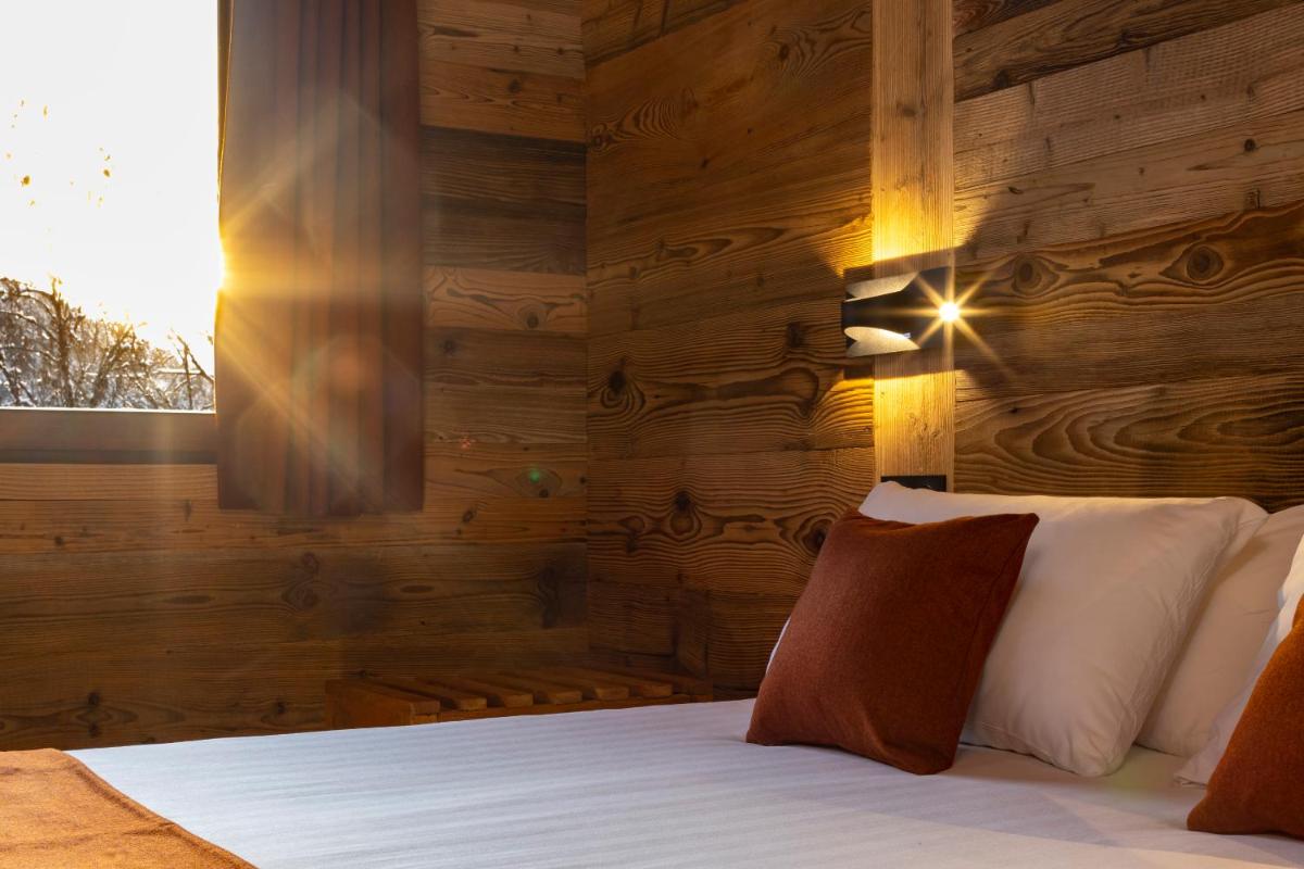 Un ou plusieurs lits dans un hébergement de l'établissement Hôtel et Spa Le Vermont