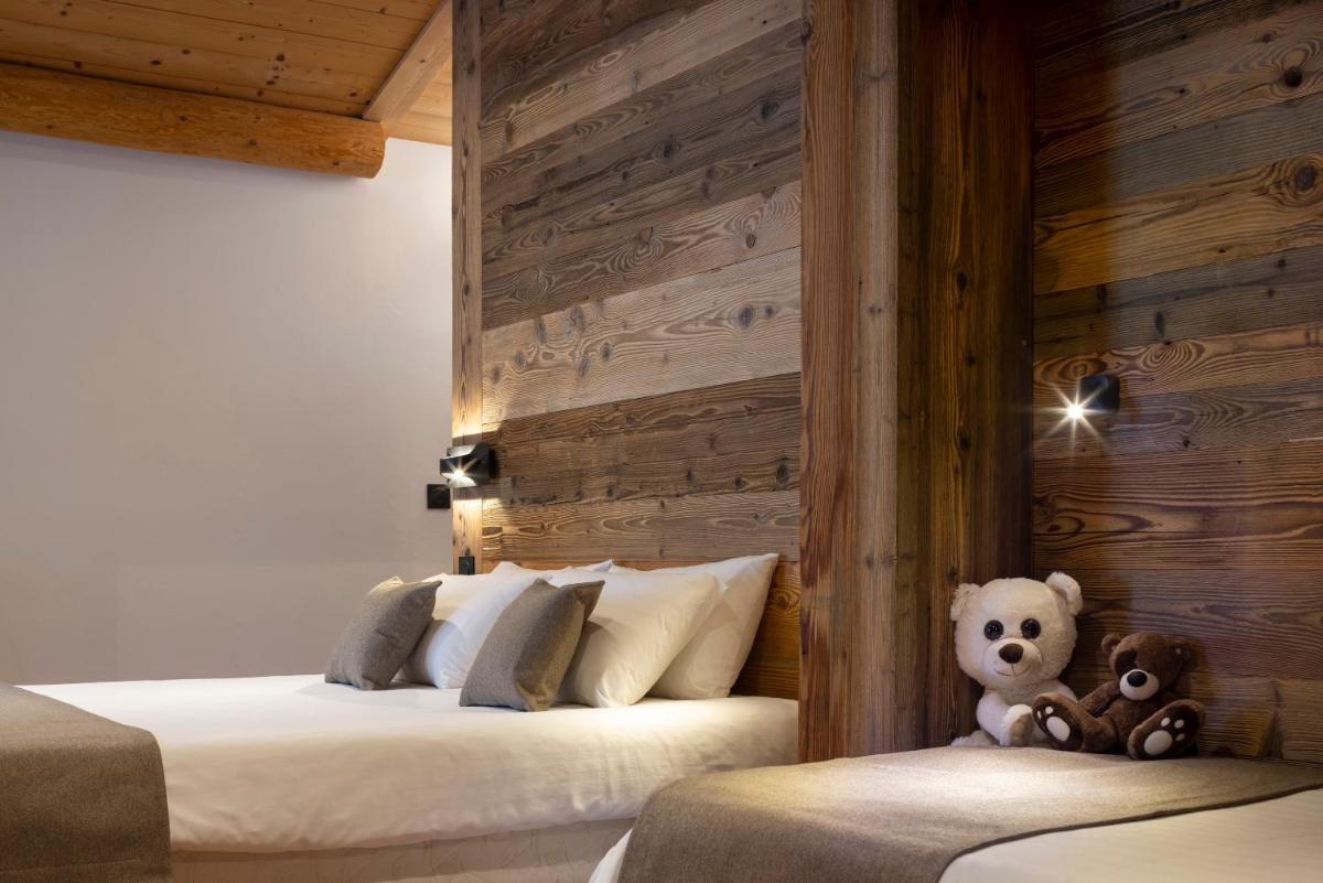 Un ou plusieurs lits dans un hébergement de l'établissement Hôtel et Spa Le Vermont