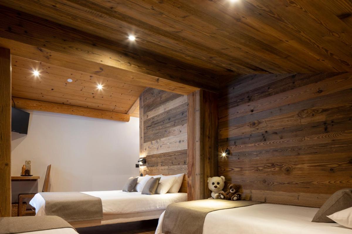 Un ou plusieurs lits dans un hébergement de l'établissement Hôtel et Spa Le Vermont