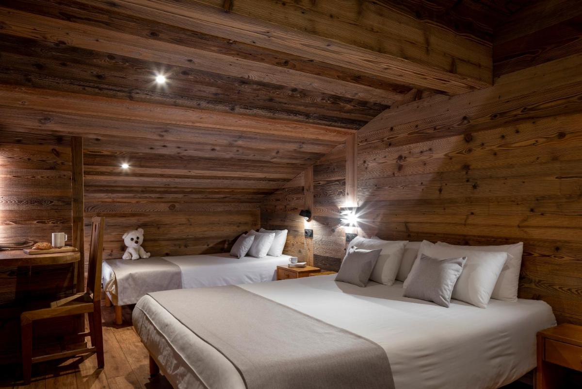 Un ou plusieurs lits dans un hébergement de l'établissement Hôtel et Spa Le Vermont