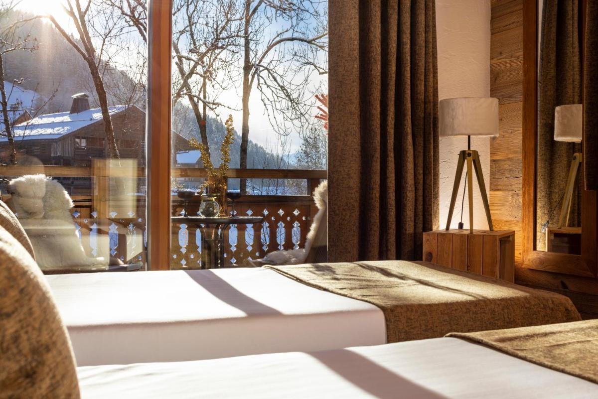 Un ou plusieurs lits dans un hébergement de l'établissement Hôtel et Spa Le Vermont