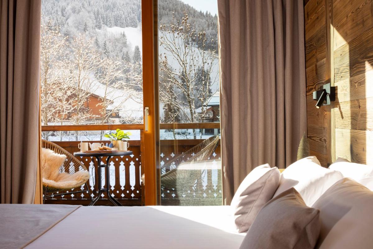 Un ou plusieurs lits dans un hébergement de l'établissement Hôtel et Spa Le Vermont