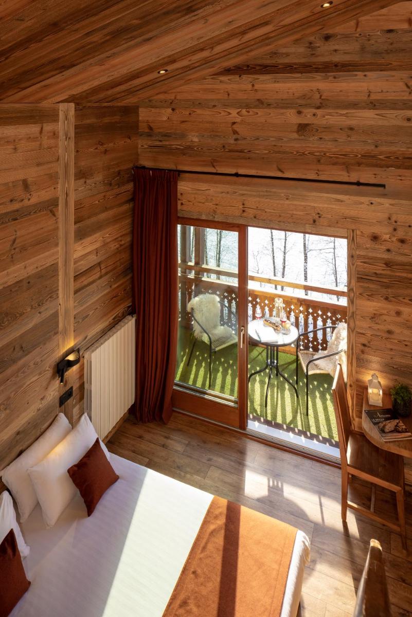 Un ou plusieurs lits dans un hébergement de l'établissement Hôtel et Spa Le Vermont
