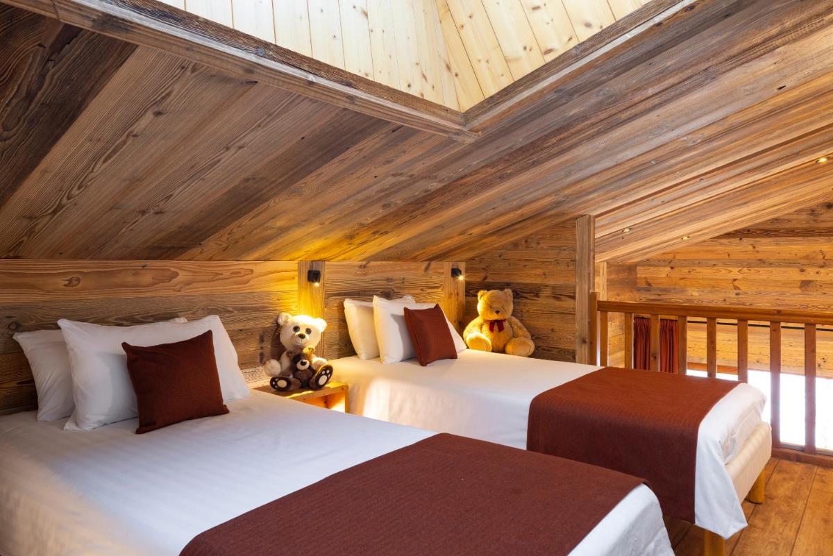 Un ou plusieurs lits dans un hébergement de l'établissement Hôtel et Spa Le Vermont
