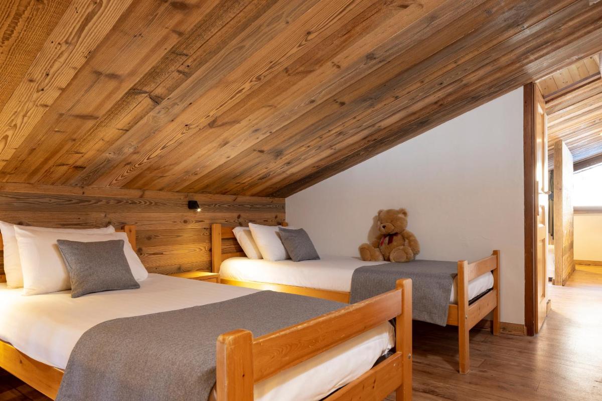 Un ou plusieurs lits dans un hébergement de l'établissement Hôtel et Spa Le Vermont