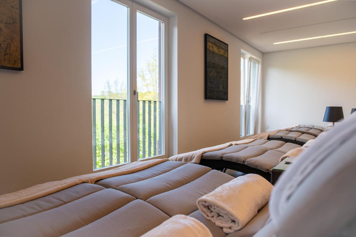 Ein Bett oder Betten in einem Zimmer der Unterkunft Neumühle Resort & Spa