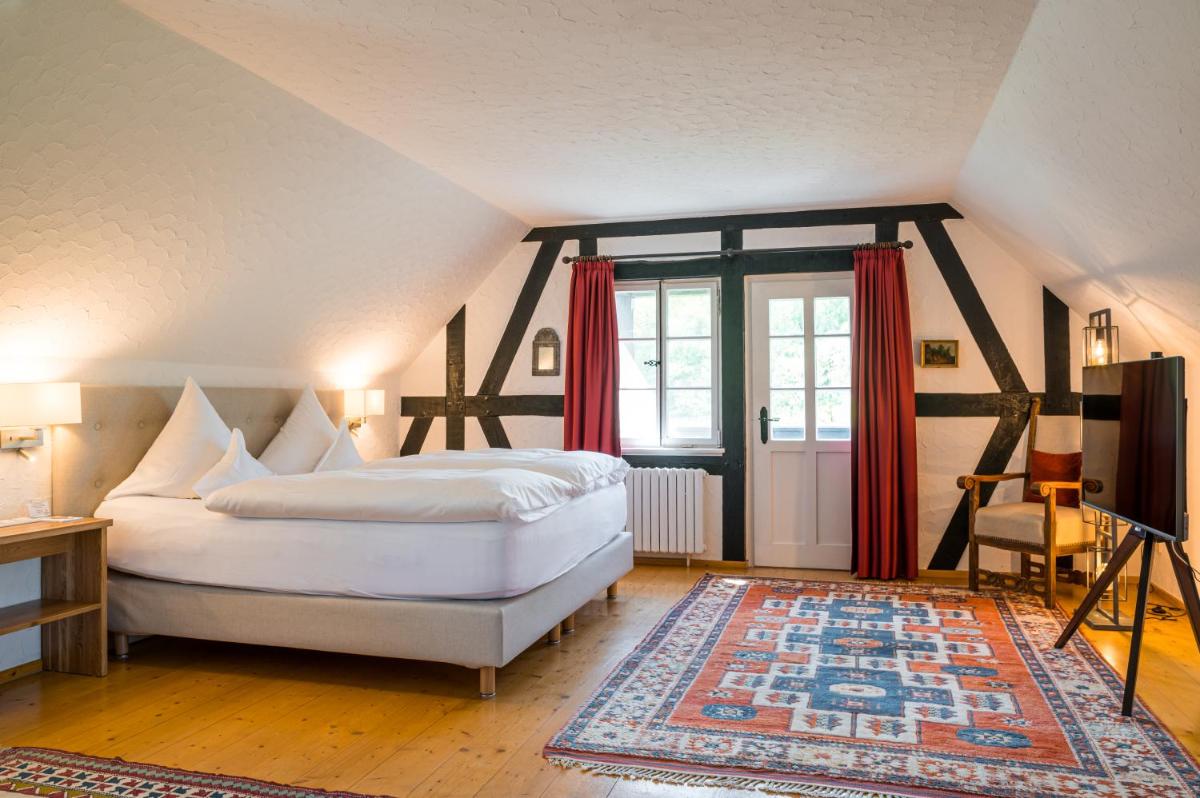 Ein Bett oder Betten in einem Zimmer der Unterkunft Neumühle Resort & Spa