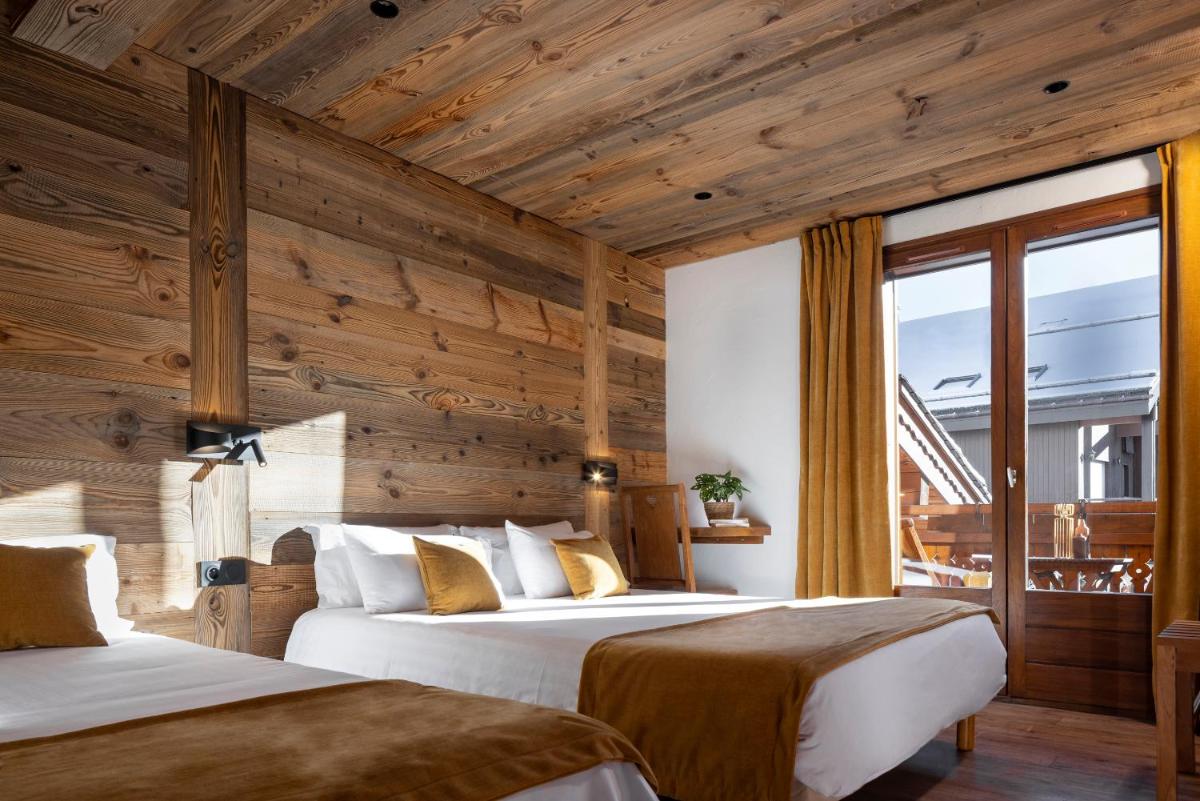 Un ou plusieurs lits dans un hébergement de l'établissement Hôtel et Spa Le Vermont