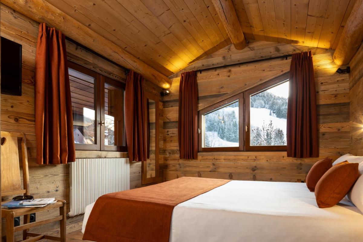 Un ou plusieurs lits dans un hébergement de l'établissement Hôtel et Spa Le Vermont