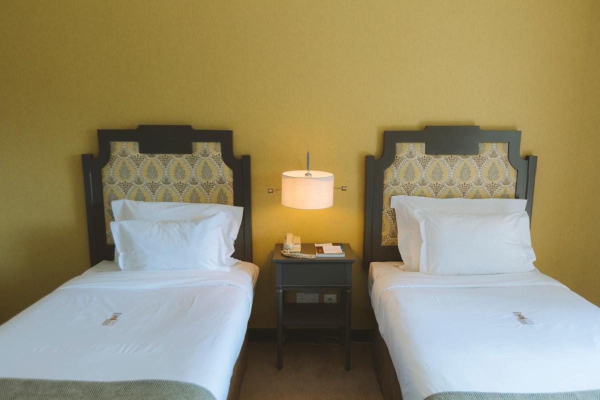 Uma cama ou camas num quarto em Conimbriga Hotel do Paço