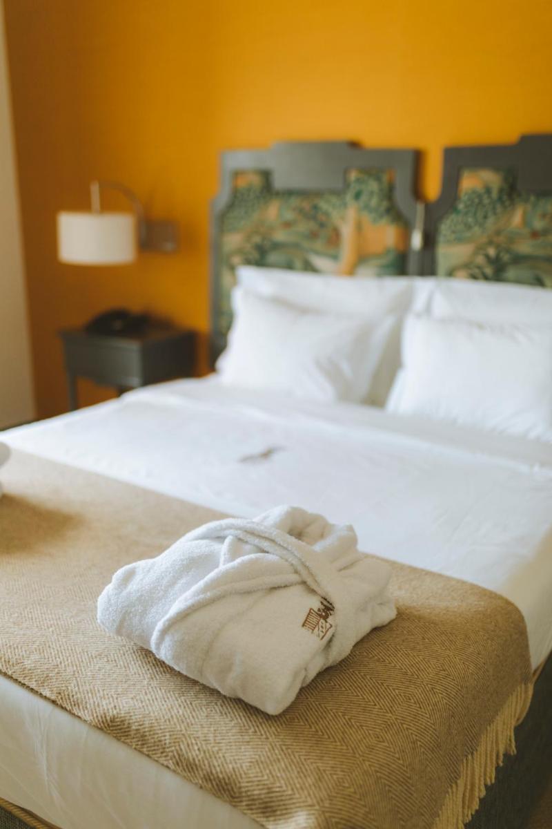 Uma cama ou camas num quarto em Conimbriga Hotel do Paço