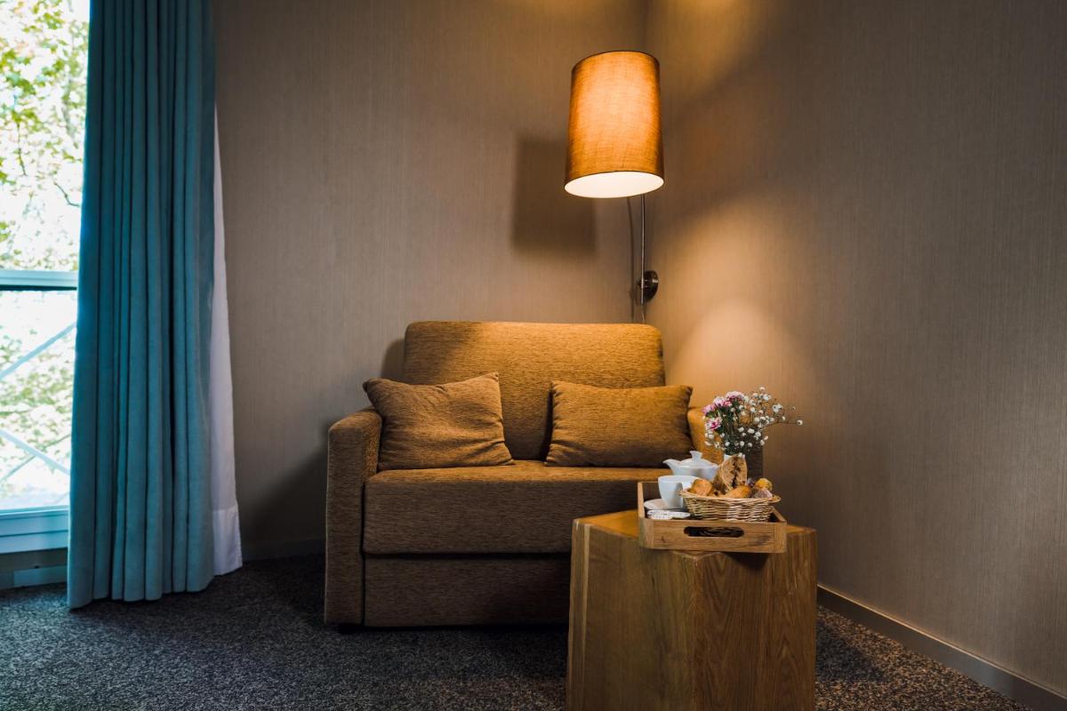 Coin salon dans l'établissement Alysson Hôtel