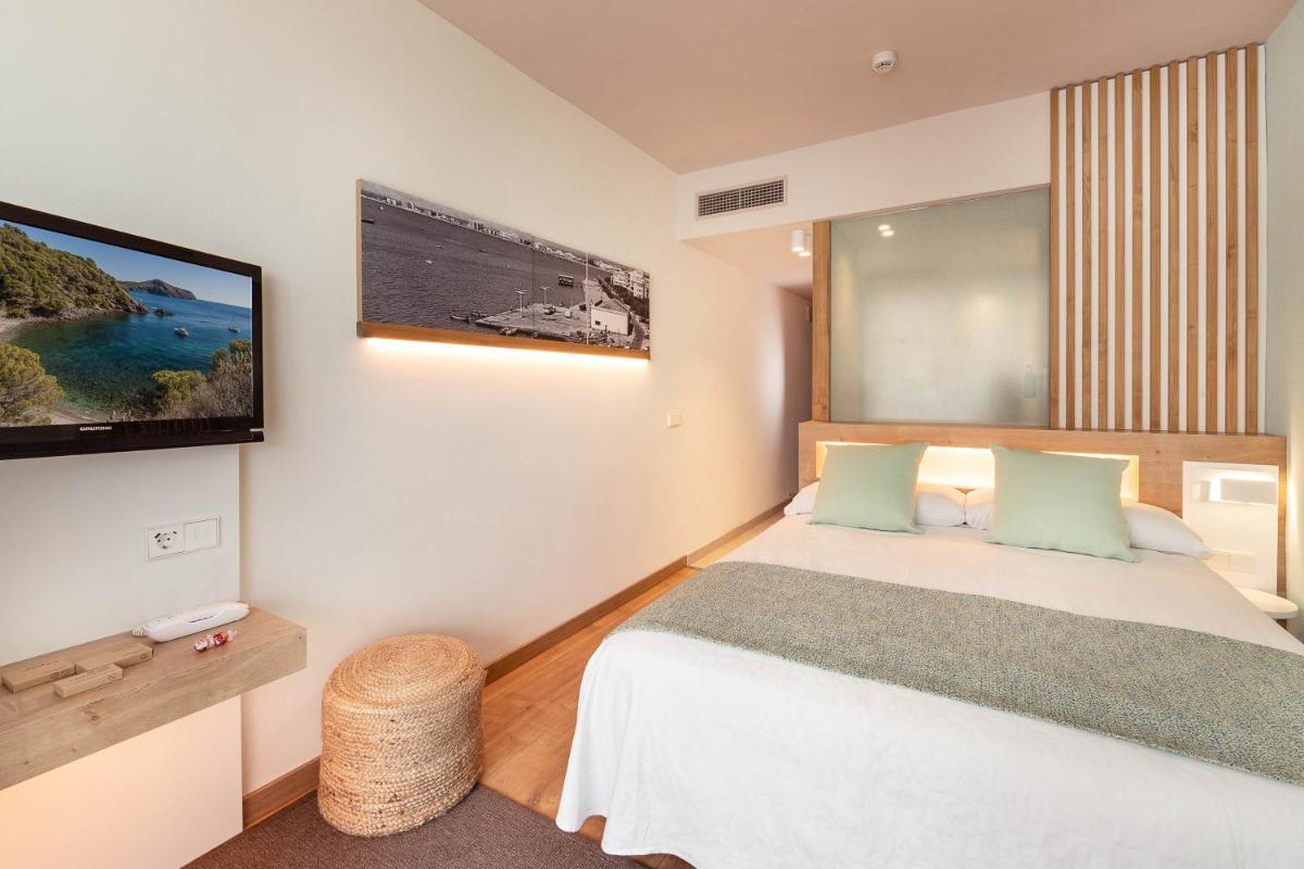 Cama o camas de una habitación en Hotel Montecarlo Spa & Wellness