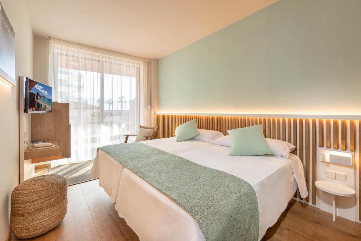 Cama o camas de una habitación en Hotel Montecarlo Spa & Wellness