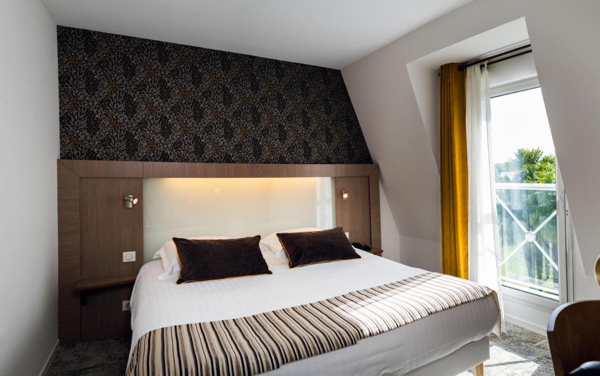 Un ou plusieurs lits dans un hébergement de l'établissement Alysson Hôtel