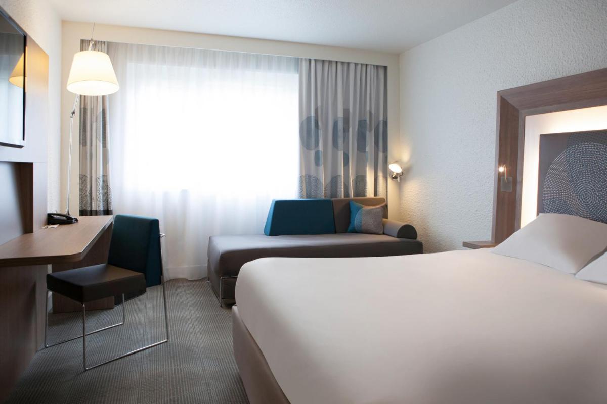 Un ou plusieurs lits dans un hébergement de l'établissement Novotel Fontainebleau Ury