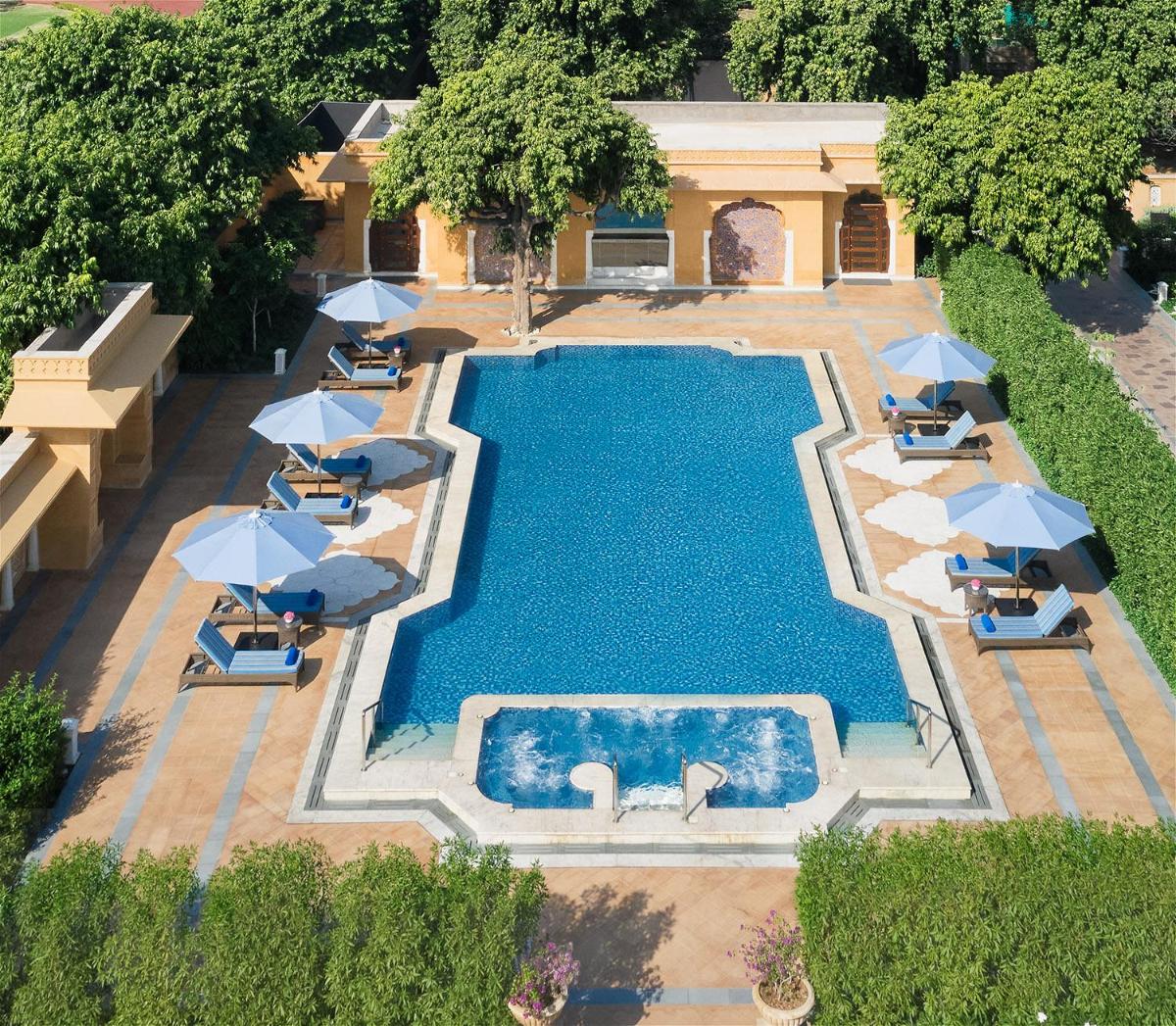 an overhead view of a swimming pool with umbrellas at Sawai Man Mahal in Jaipur