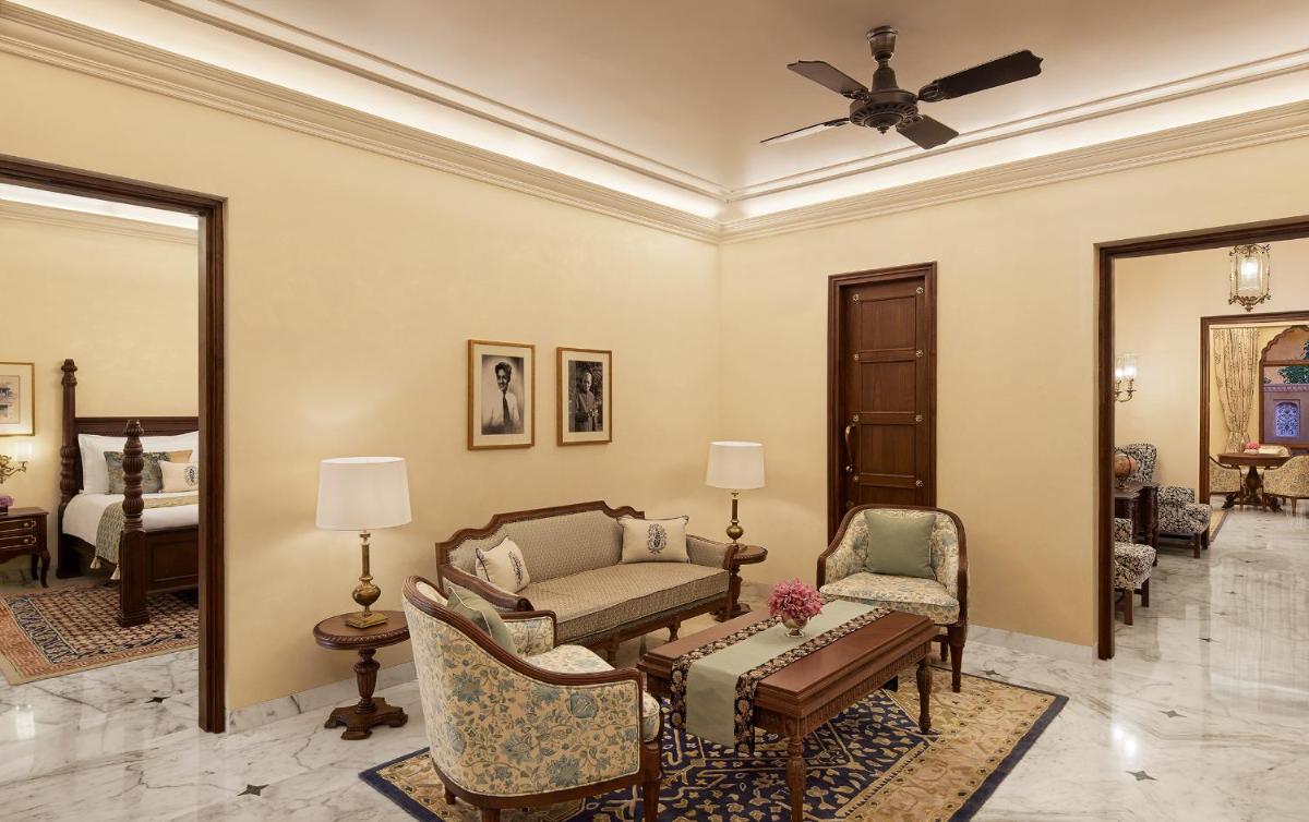 a living room with a couch and a table at Sawai Man Mahal in Jaipur