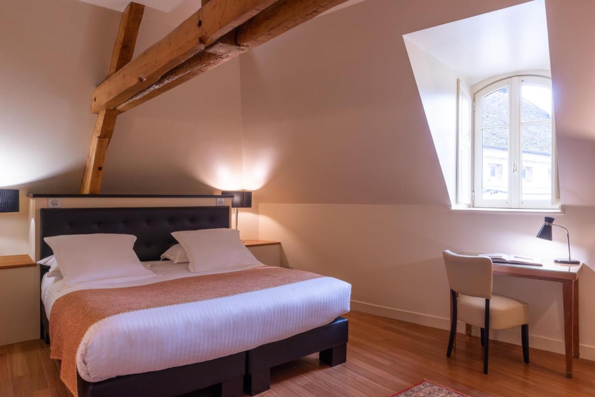 Un ou plusieurs lits dans un hébergement de l'établissement L'Hôtel