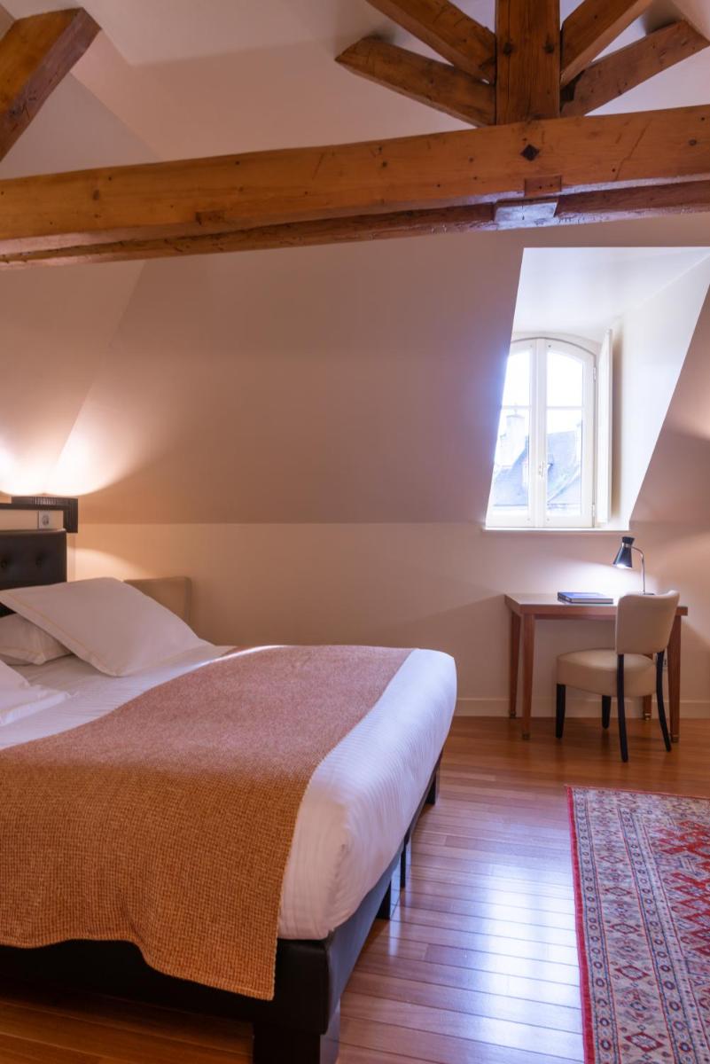 Un ou plusieurs lits dans un hébergement de l'établissement L'Hôtel
