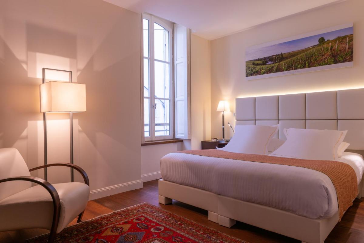 Un ou plusieurs lits dans un hébergement de l'établissement L'Hôtel