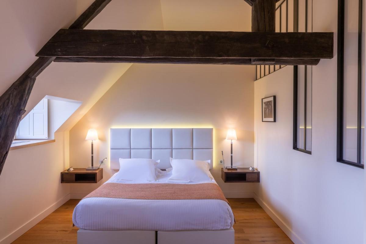 Un ou plusieurs lits dans un hébergement de l'établissement L'Hôtel