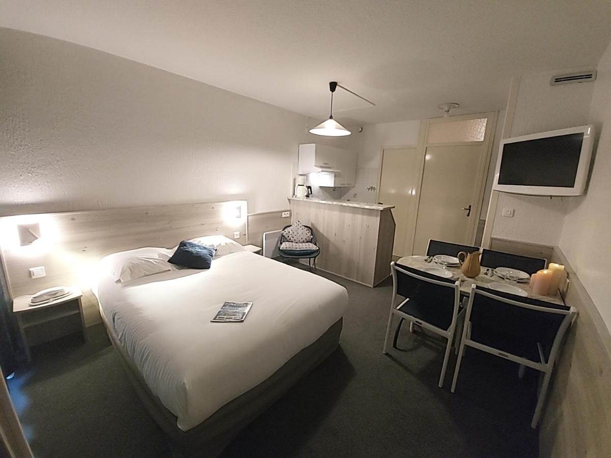 Un ou plusieurs lits dans un hébergement de l'établissement Hôtel-Résidence Le Lys