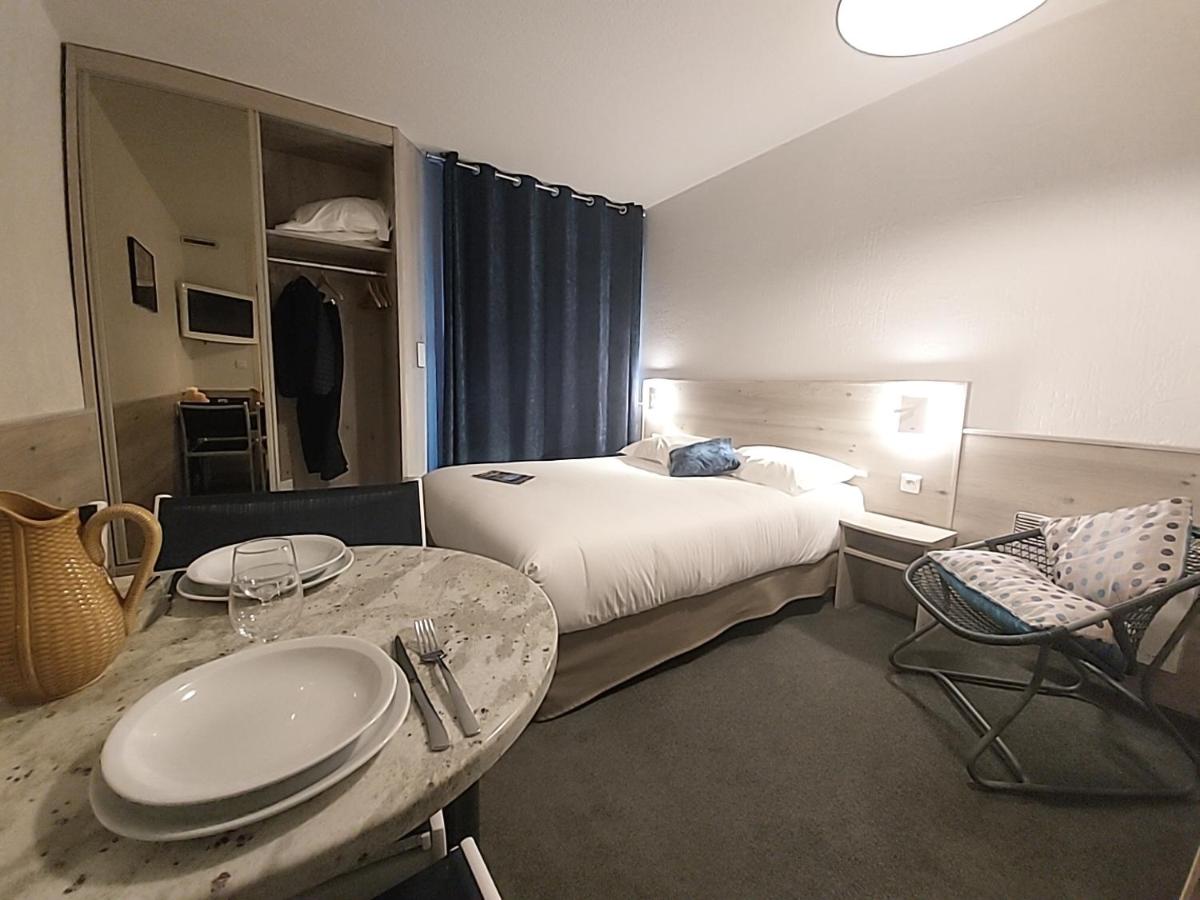 Un ou plusieurs lits dans un hébergement de l'établissement Hôtel-Résidence Le Lys