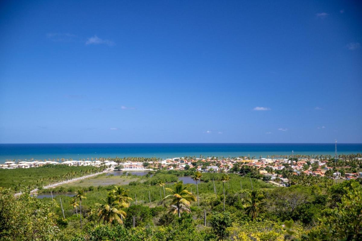 Condomínio local paradisíaco em frente à praia. - Housity