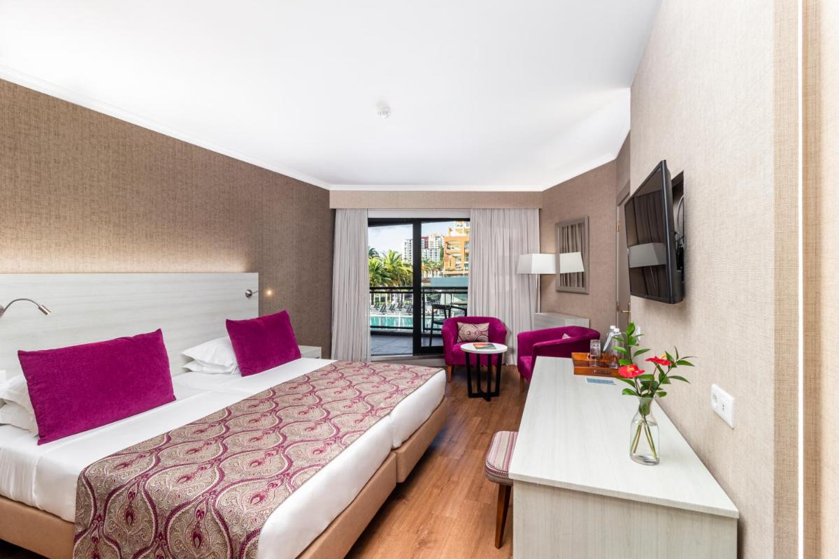 Uma cama ou camas num quarto em Enotel Lido - All Inclusive
