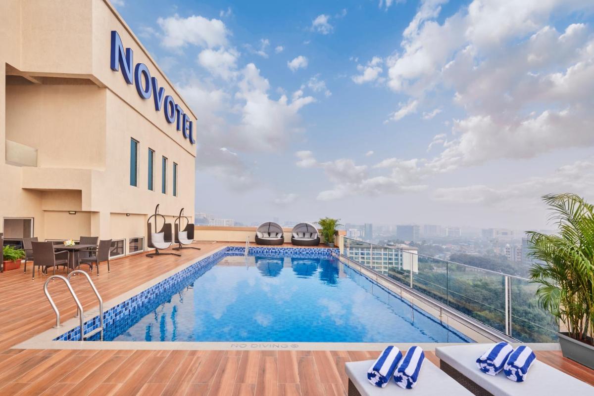a swimming pool on the roof of a hotel at Novotel Mumbai International Airport in Mumbai