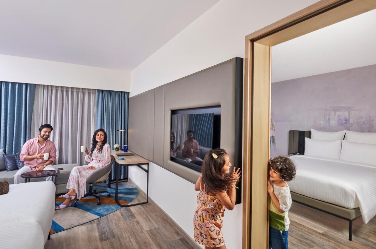 a family in a hotel room at Novotel Mumbai International Airport in Mumbai