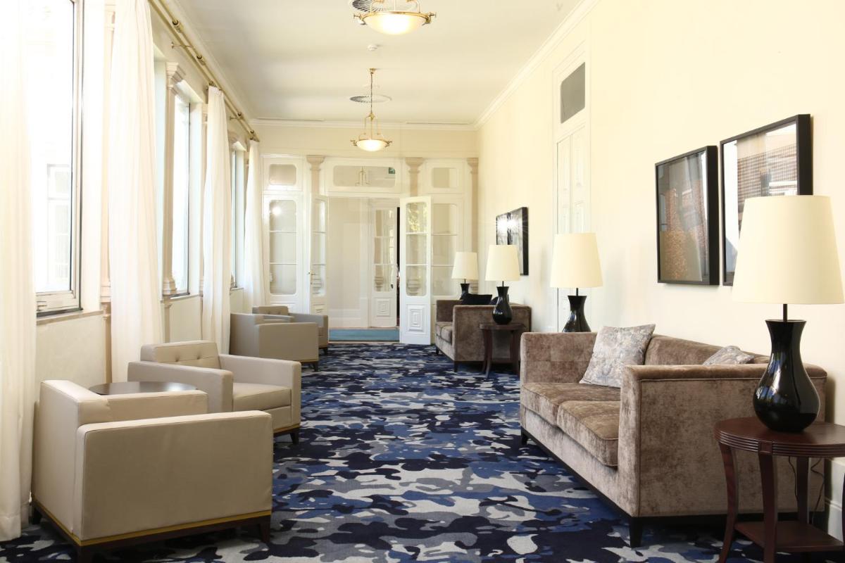 Uma área de estar em Hotel Quinta das Lagrimas - Small Luxury Hotels