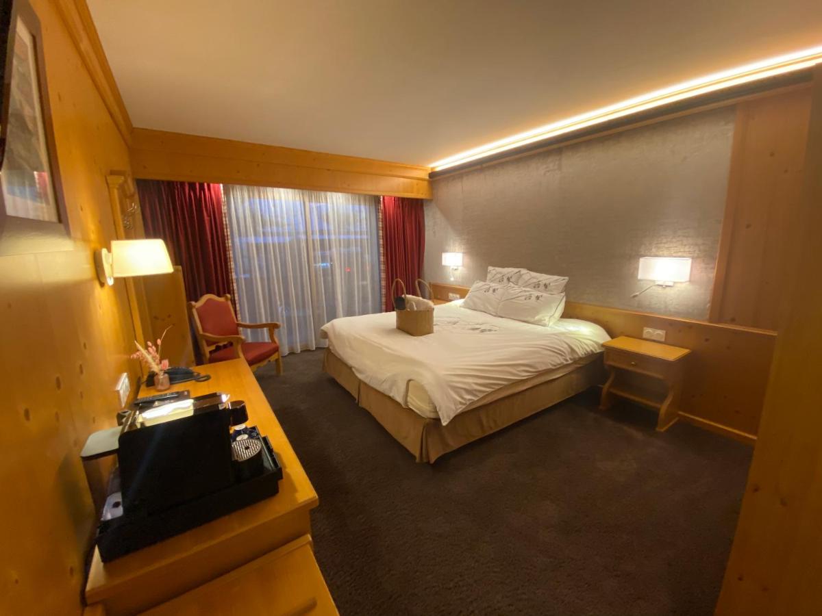 Un ou plusieurs lits dans un hébergement de l'établissement Hôtel Macchi Restaurant & Spa