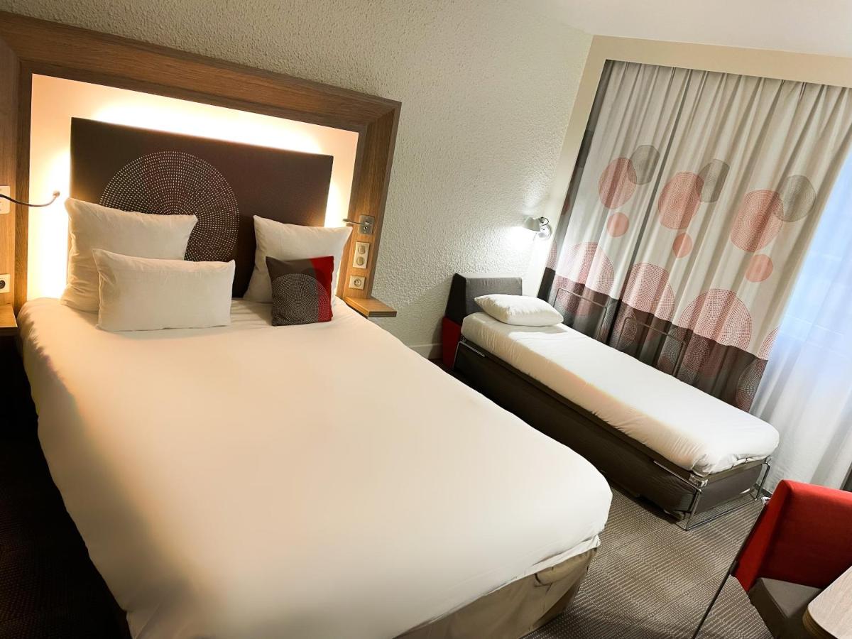 Un ou plusieurs lits dans un hébergement de l'établissement Novotel Fontainebleau Ury