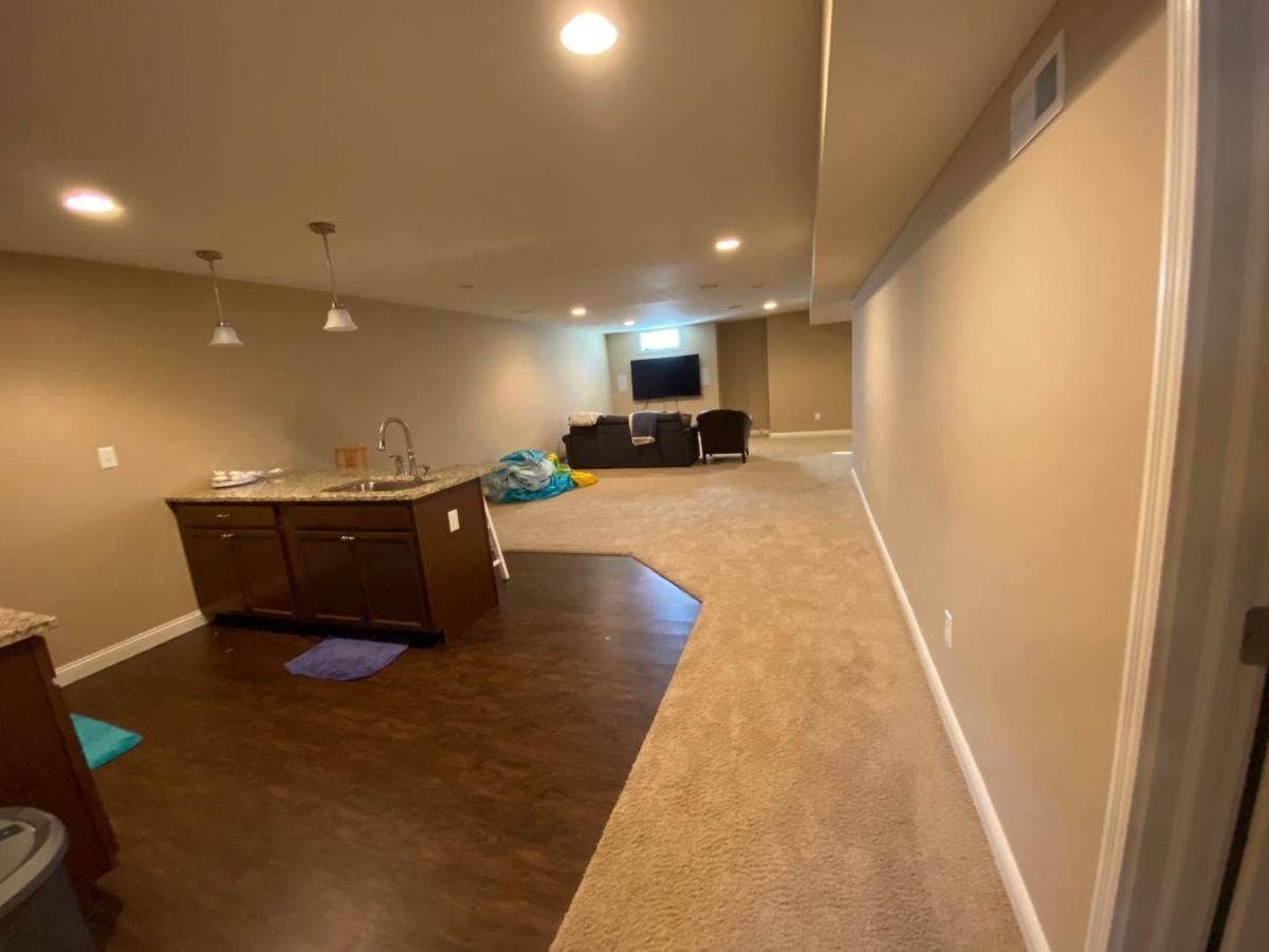 Private basement bedroom with private bathroom, kitchen, and living room with large screen television - Housity