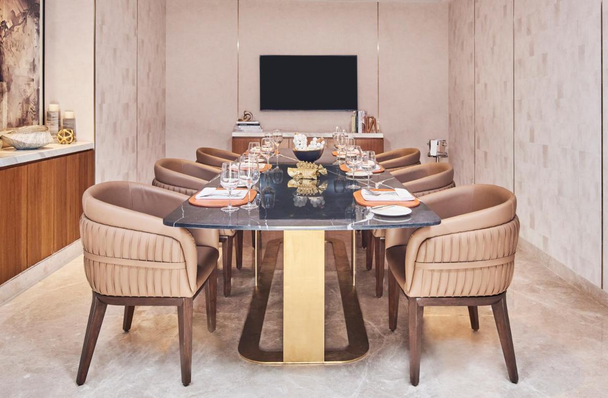 a dining room with a table and chairs at Novotel Mumbai International Airport in Mumbai