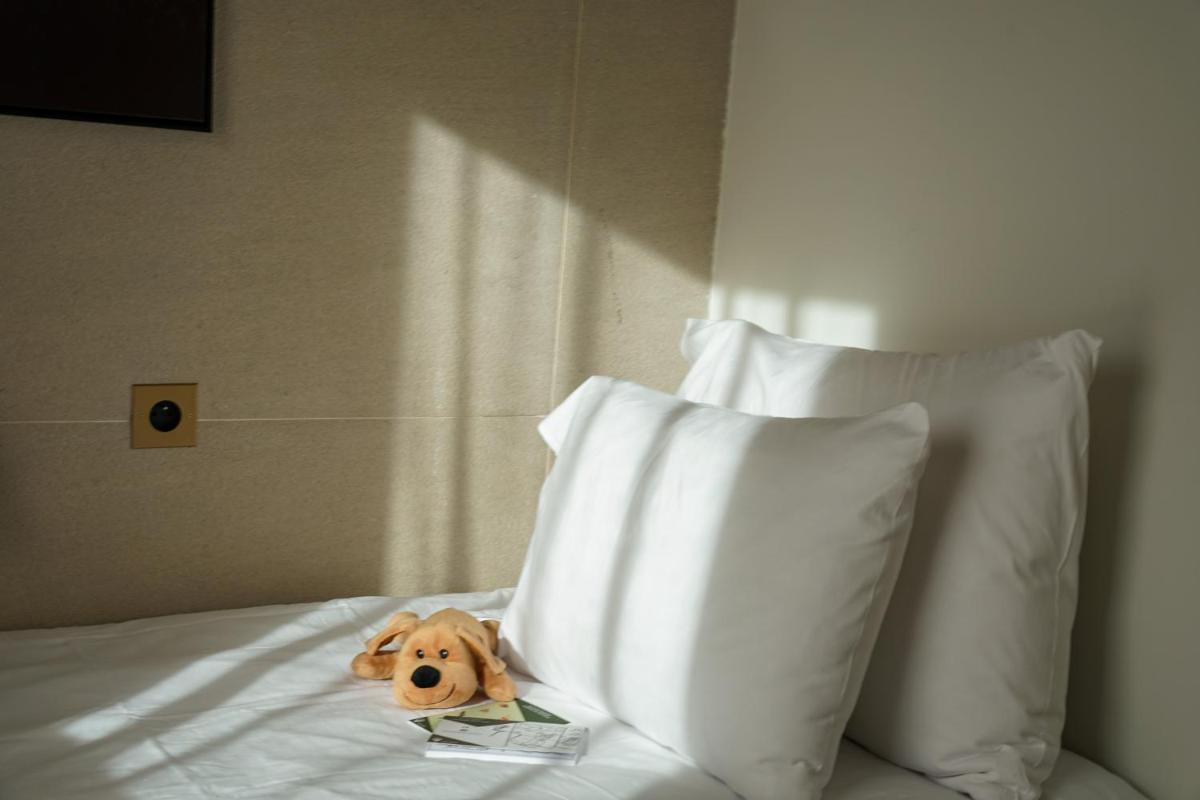 Un ou plusieurs lits dans un hébergement de l'établissement Hôtel Le Diamond Rock