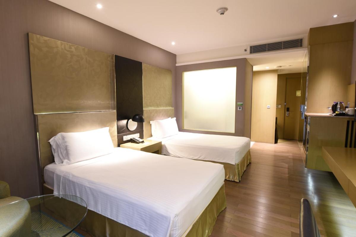 a hotel room with two beds and a window at Holiday Inn New Delhi Aerocity by IHG in New Delhi
