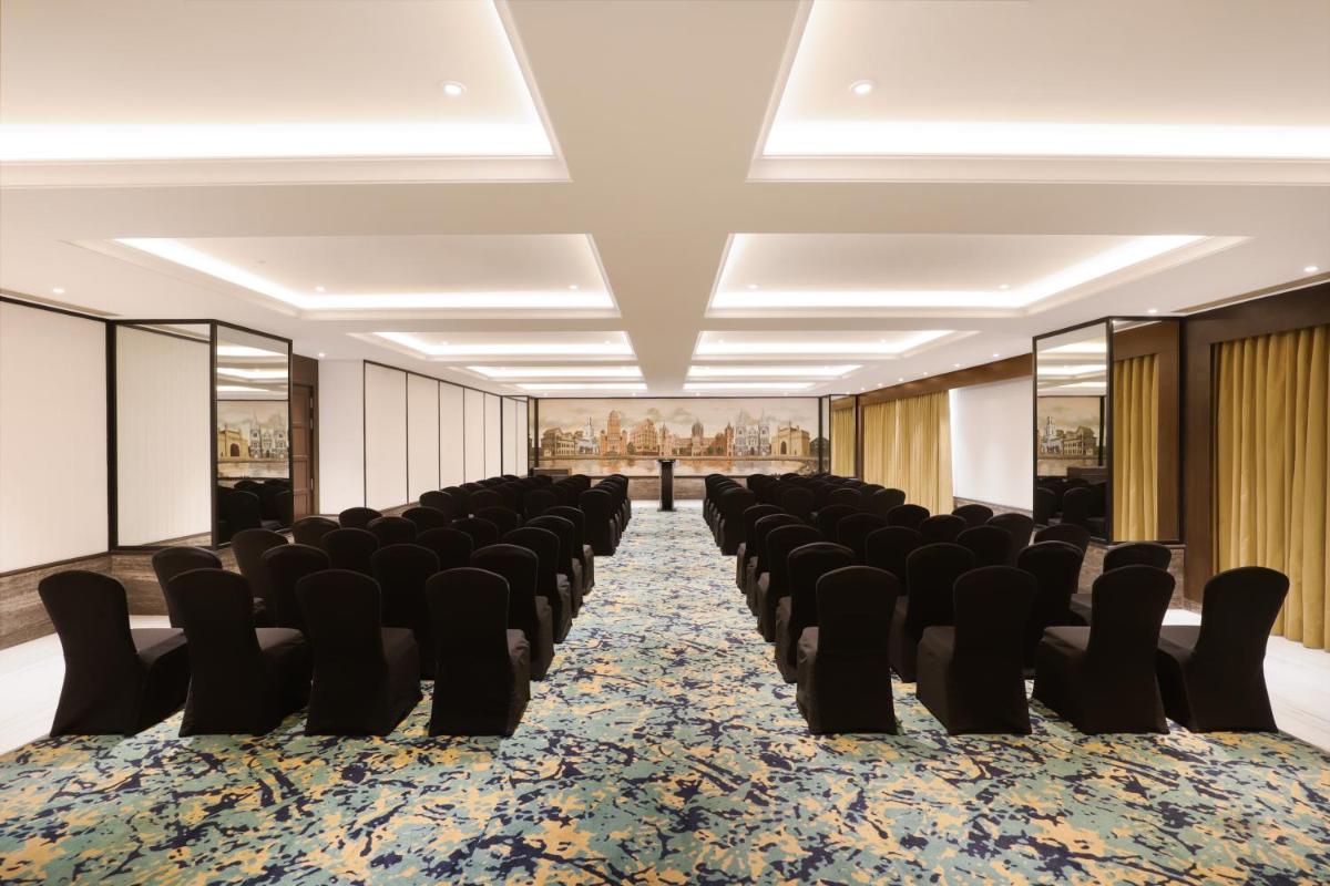 a large room with chairs and a carpet at Lemon Tree Premier, Mumbai International Airport in Mumbai