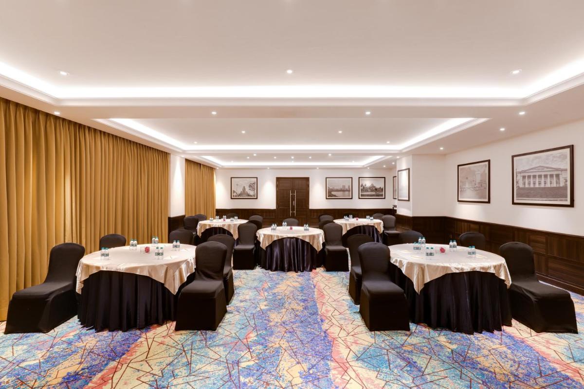 a conference room with tables and chairs in it at Lemon Tree Premier, Mumbai International Airport in Mumbai