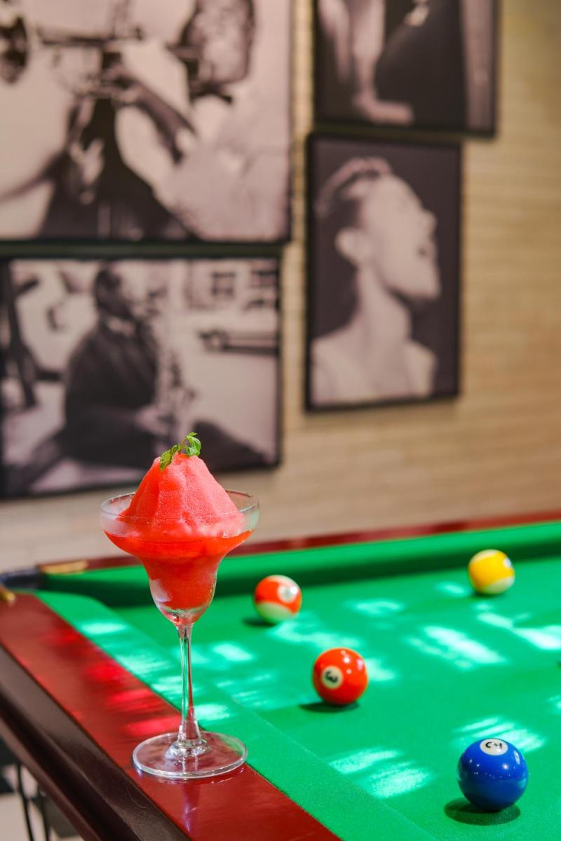 a drink in a martini glass on a pool table at Lemon Tree Premier, Mumbai International Airport in Mumbai